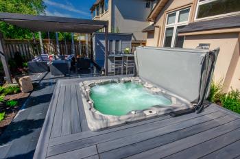 Inground hot tub in wood deck